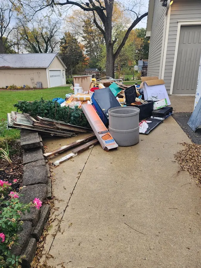 Dumpster being loaded with debris for Estate Cleanout Dumpster Rental in Herndon